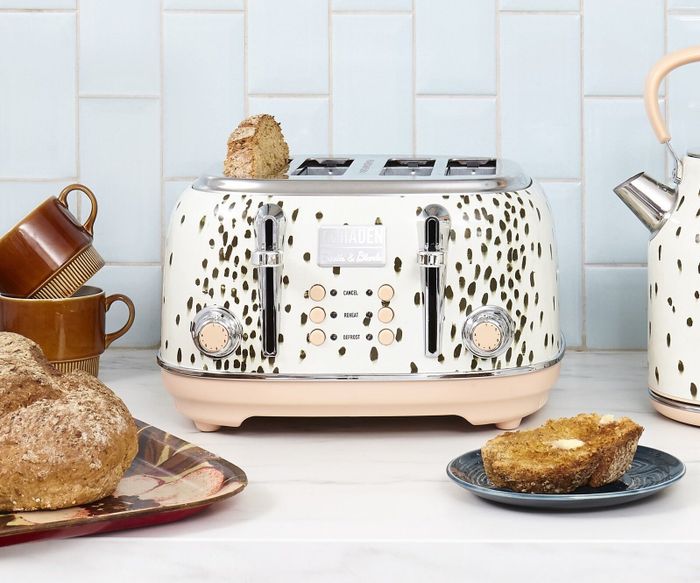 A four-slice toaster with two dials, six buttons, and a black spotted finish