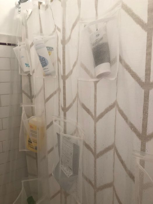Mytour editor Elizabeth's shower viewed from the inside, featuring the clear liner holding her bath essentials in the multiple spacious pockets arranged throughout.