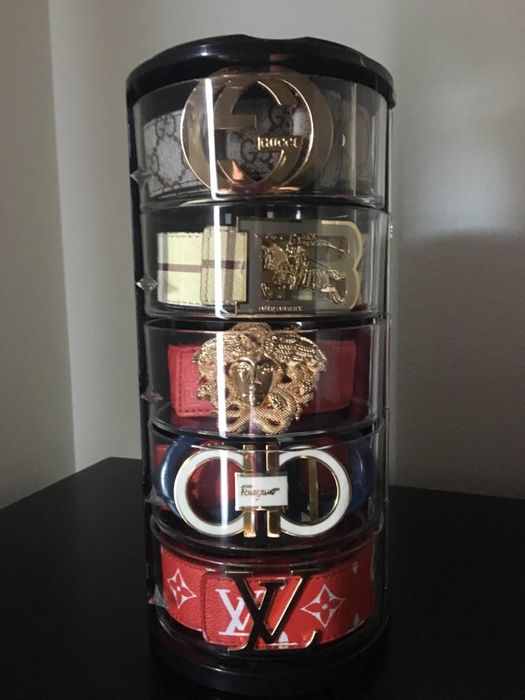 Reviewer's belts neatly arranged inside the acrylic organizer case