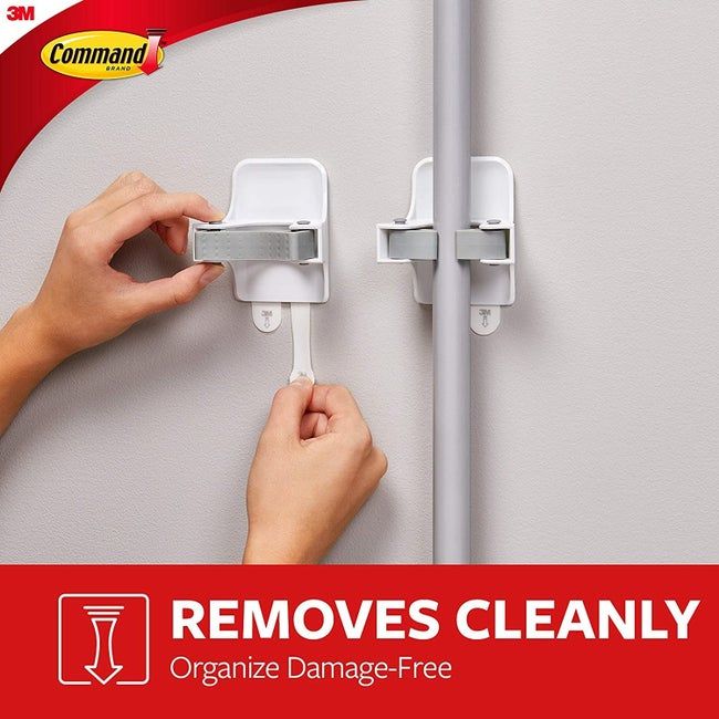 Two hooks designed for hanging broom handles.