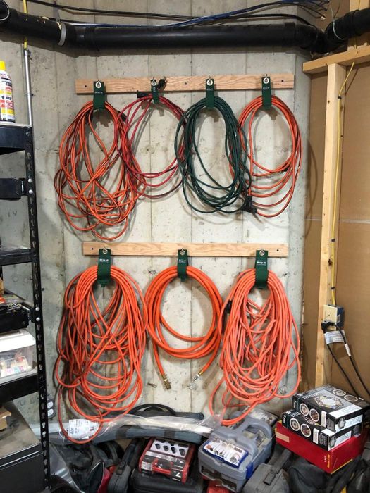 Garage wall organized with neatly hung extension cords and tools, demonstrating smart storage solutions