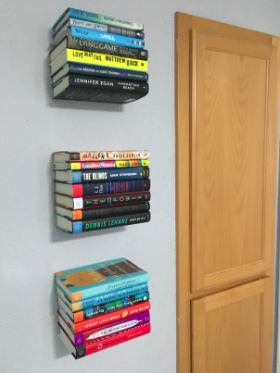 A reviewer's photo of three sets of floating bookshelves stacked together