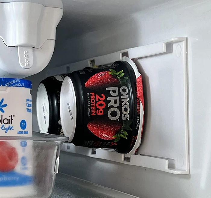 Another reviewer's fridge showing the organizer placed sideways to store Oikos yogurt