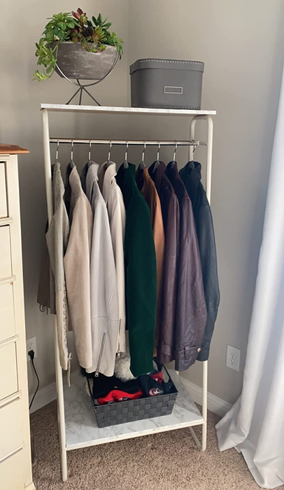 a reviewer's photo of a clothing rack filled with hanging garments