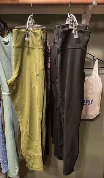 Two hangers stacked with leggings, positioned back to back