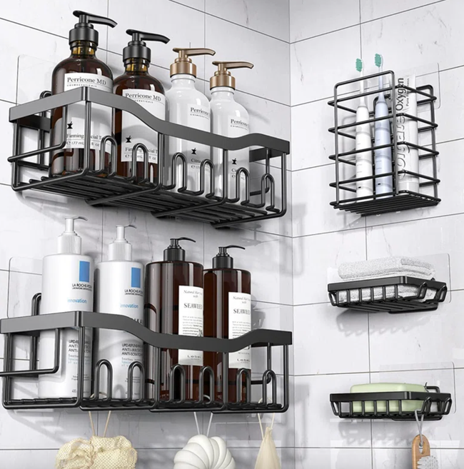 A shower with black wire shelves holding various skincare and haircare products, including lotions, shampoos, shower gels, towels, and a sponge.