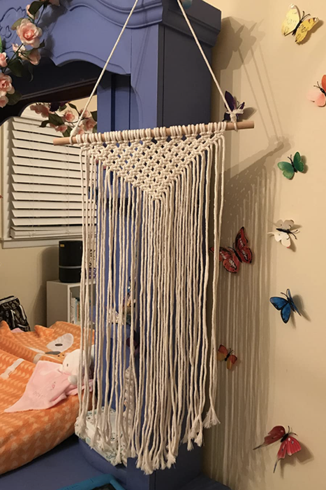 A reviewer's macramé wall hanging, still empty of any hair accessories