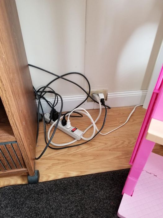 A reviewer's power strip with various cords and cables plugged into it.