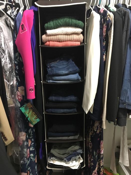 A reviewer’s closet, featuring the hanging organizer filled with clothes.