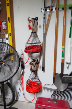 Another reviewer's garage wall displaying two extension cord holders