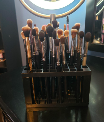 Another review image where the user has neatly placed several makeup brushes into the organizer cube.