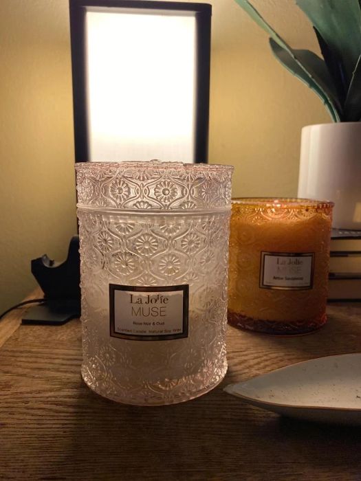 a light pink glass candle