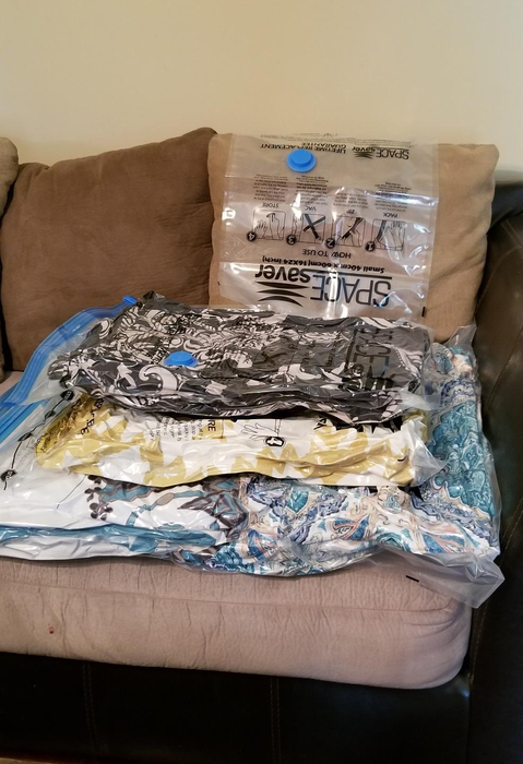 same reviewer's comforters neatly compressed inside vacuum storage bags