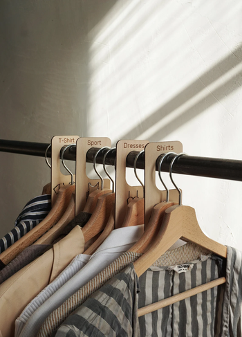 wooden dividers neatly organizing clothes on a rack