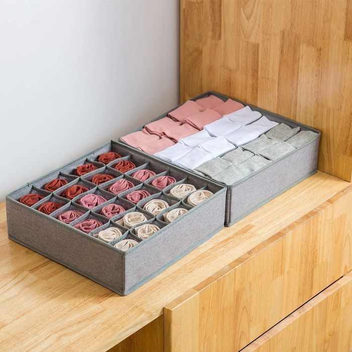 Underwear and socks neatly rolled inside a storage divider insert