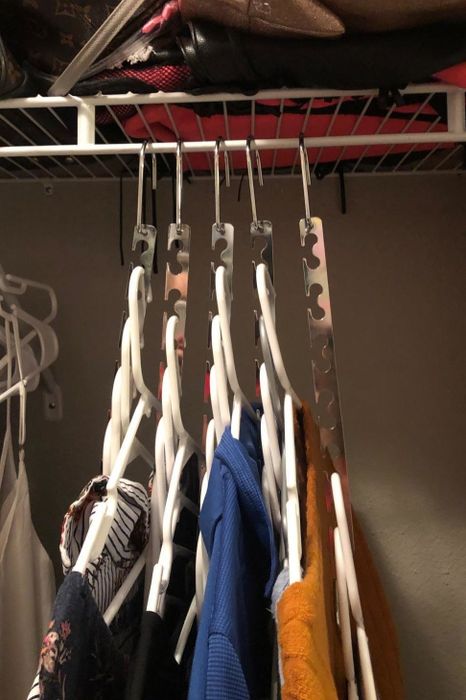The same reviewer shows off their closet now organized with closet cascaders, opening up much more space on the clothes rack