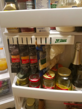 A review photo of the door organizer holding bags of cheese.