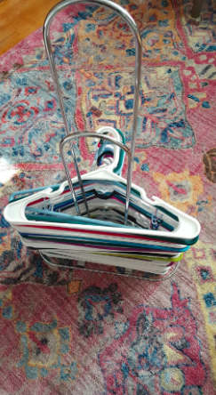 A photo of the reviewer's neatly organized stack of hangers after using the hanger stacker.
