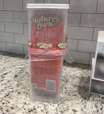 An image showing the rectangular bread dispenser with a loaf placed inside.