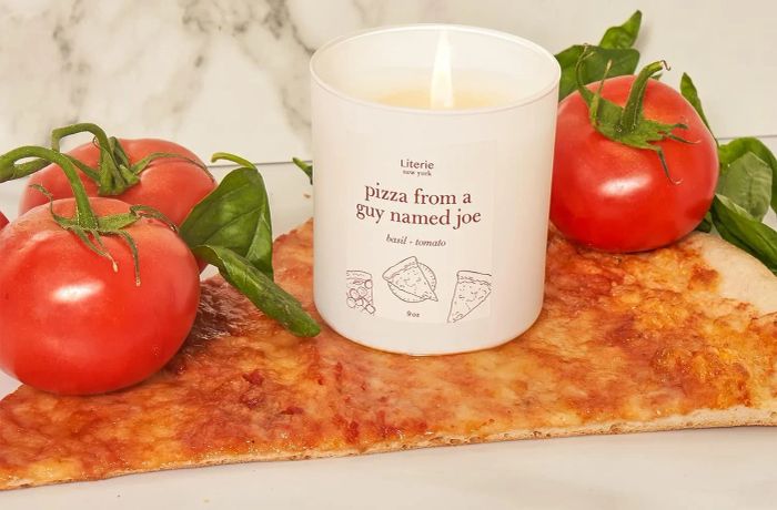 a white tomato and basil-scented candle with 
