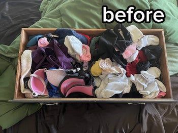 A reviewer's photo showing a messy drawer before using organizers.
