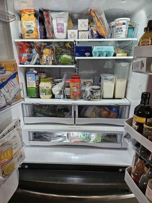 A reviewer’s fridge organized with clear bins.