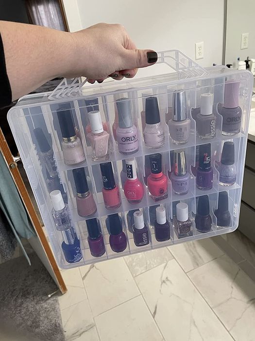 Reviewer holding the nail polish organizer by its handle.