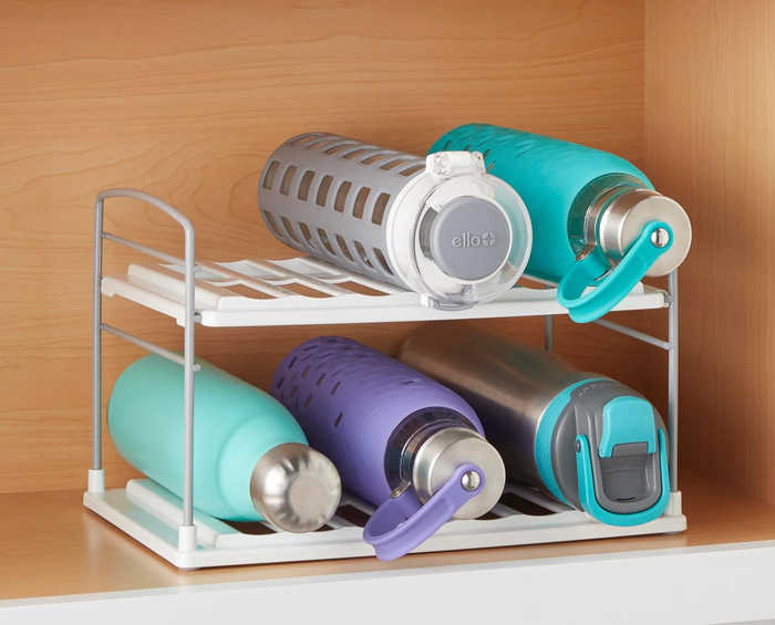 A variety of water bottles neatly arranged on an organizer.