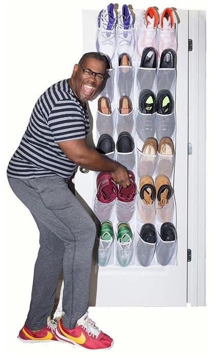 A person placing shoes into the hanging organizer