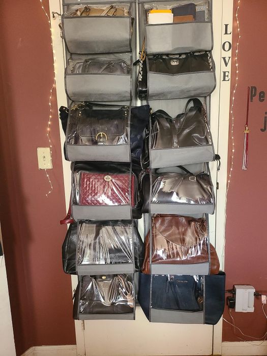 A reviewer's closet door with two grey organizers hanging over it, each holding several purses