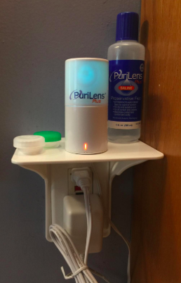 Another reviewer’s image with contact items and several other things neatly organized on the outlet shelf