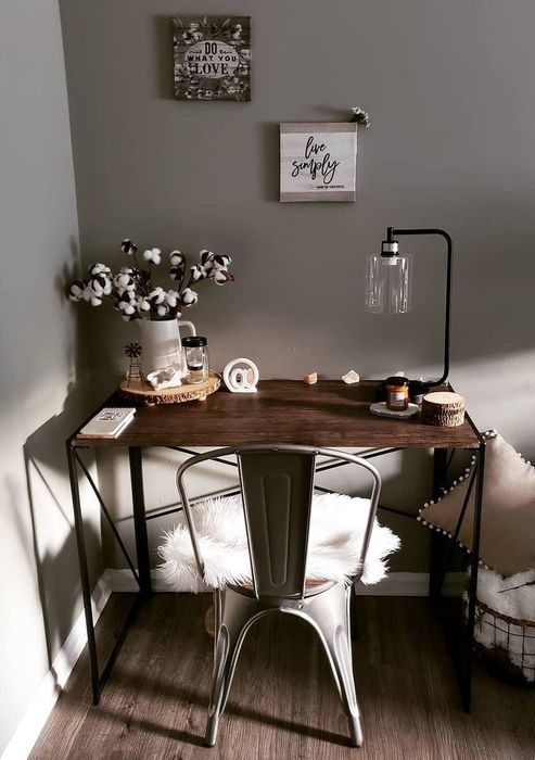 a reviewer's image of the desk featuring a wooden top and metal legs placed in a room