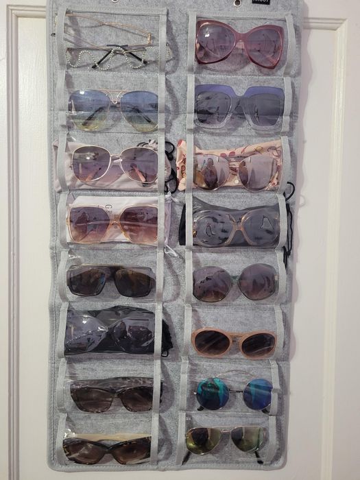 Close-up of another reviewer's gray organizer holding various pairs of sunglasses