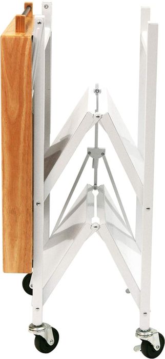 A folding cart made of wood and metal with wheels, shown in its compact, collapsed form, ideal for kitchens or small spaces requiring versatile storage.