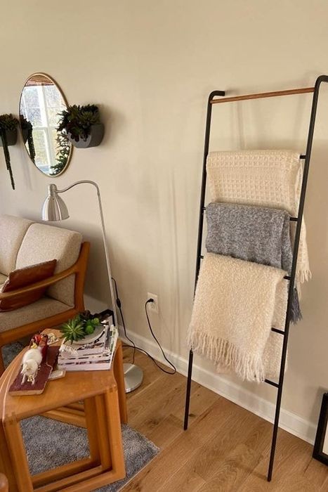 The same leaning ladder now displaying a reviewer's collection of scarves.