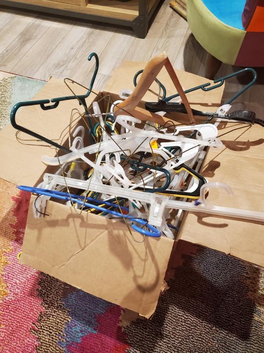 reviewer’s box filled with a chaotic mess of hangers