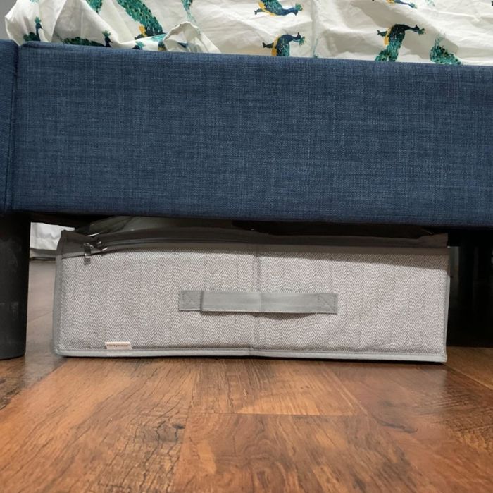 A photo from a reviewer showing the under-bed storage container placed beneath their bed