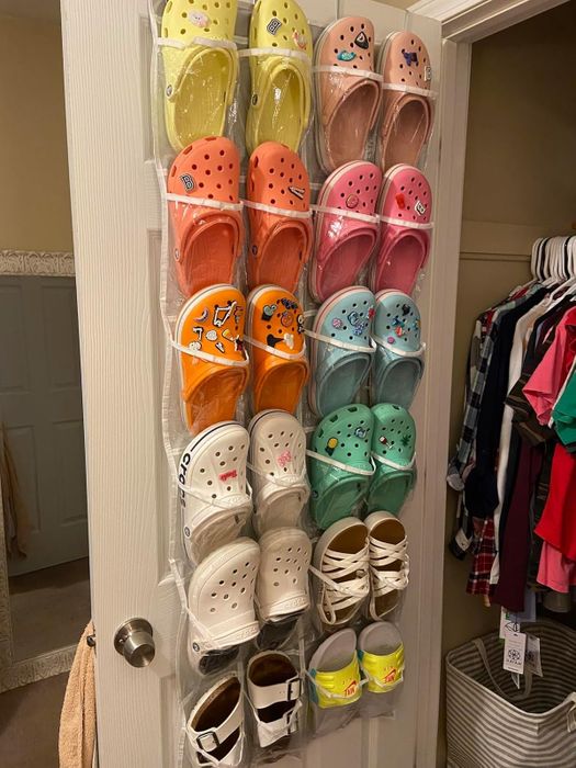 Reviewer shows a photo of shoes stored in the hanging sleeve organizer.