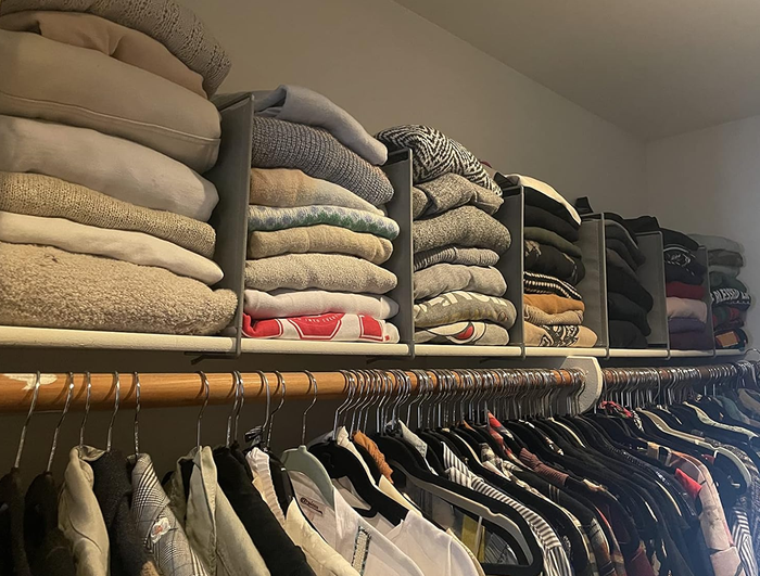 top view of reviewer’s closet with sweater stacks separated by dividers
