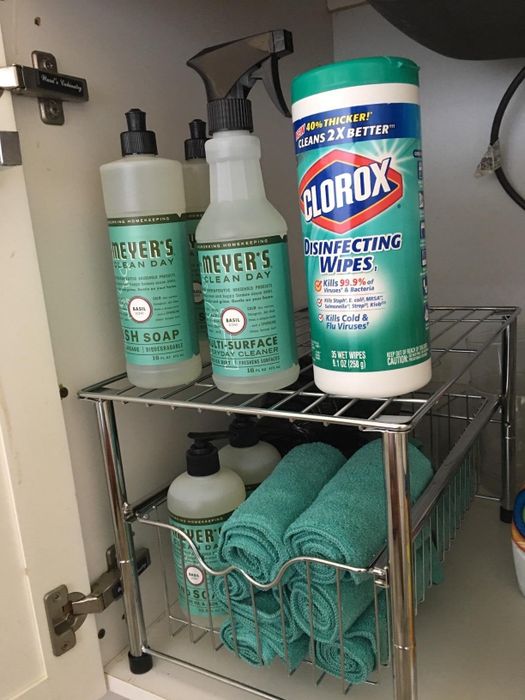 A reviewer using the drawer in the under-sink cabinet to store cleaning supplies.