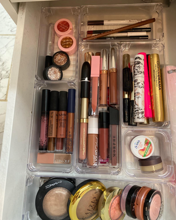 Additional makeup arranged neatly in rectangular and square containers.