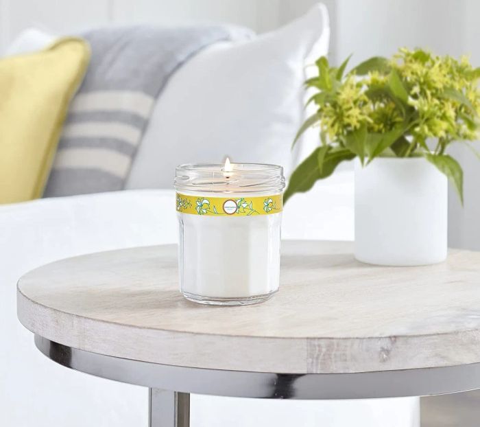 Mrs. Meyer's Honeysuckle candle glowing softly on an end table