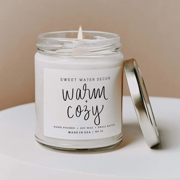 a candle with a white label on it that says