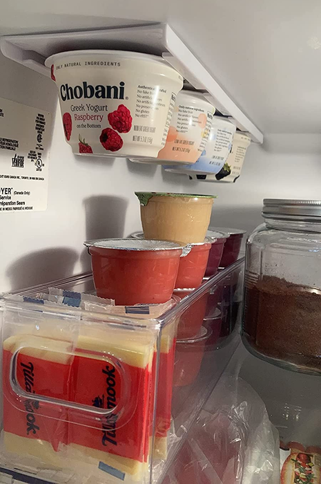 A reviewer's fridge showcasing the organizer filled with Chobani yogurts