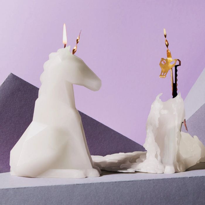 a white unicorn candle that melts away to reveal a skeletal figure