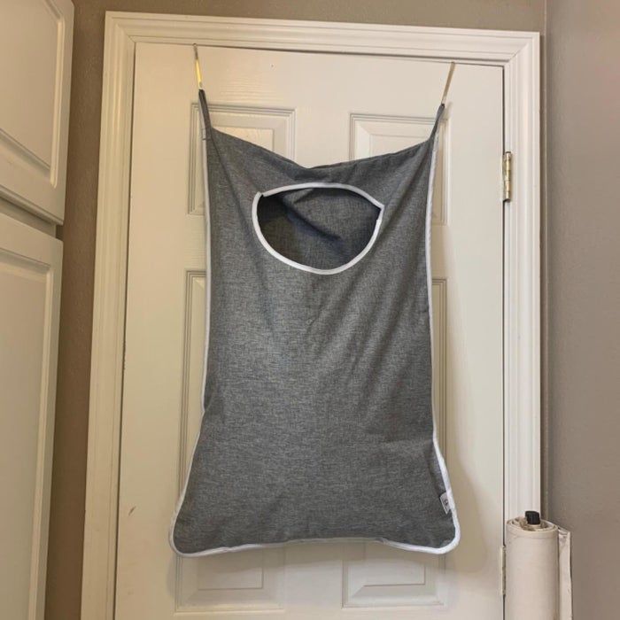 The laundry hamper hanging over a door
