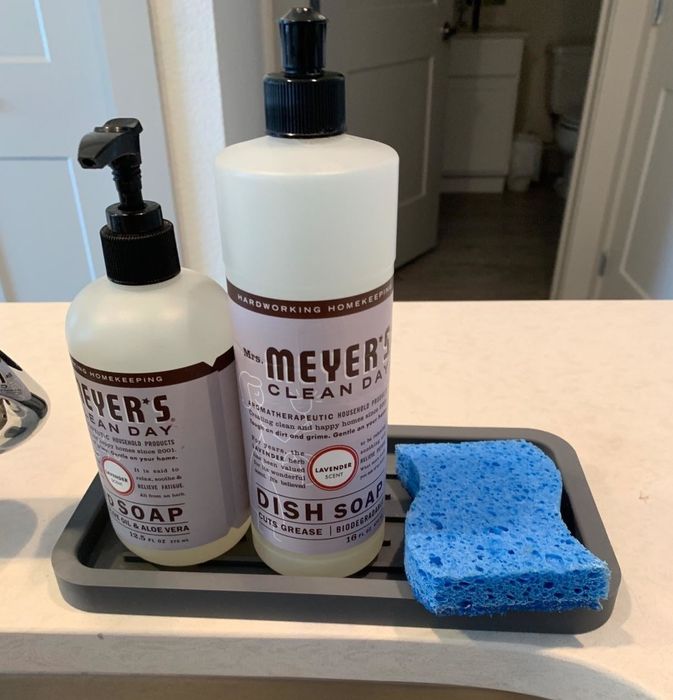 The organizer holding a sponge, dish soap, and hand soap neatly arranged