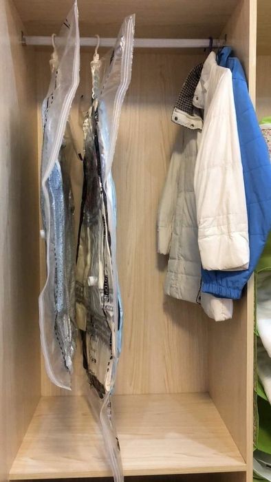 The same clothes, now with all the air sucked out of the bag, taking up a tiny fraction of the space they once did.