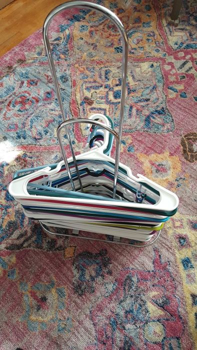 The hangers are now neatly arranged on the organizer rack, showcasing a tidy and organized closet.