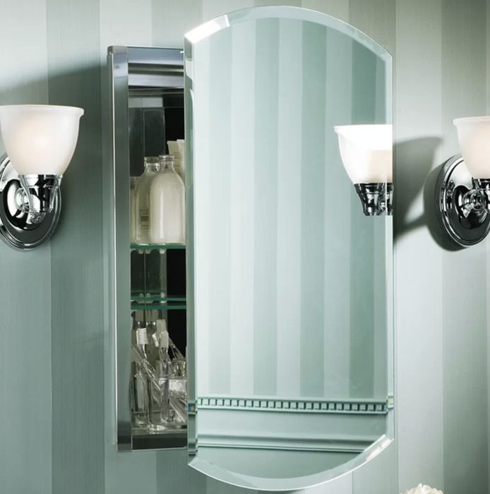 A half-opened frameless mirrored medicine cabinet showcasing its modern design.